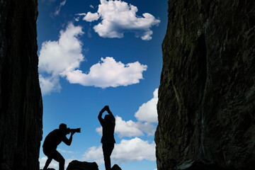 Silhouette of a woman and photographer with a backpack in mountain Torghatten, Northern Norway,scandinavia,Europe