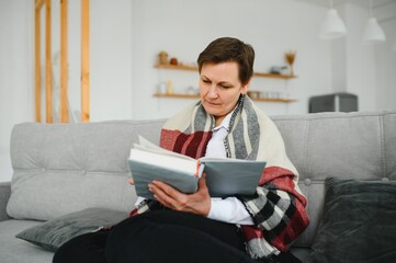 Portrait of senior woman reading book