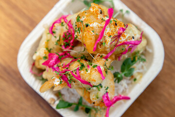 shrimp prawn with pickled onion pink and fried noodles in bamboo bowl low light out of focus with grain