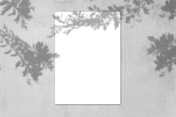 Empty white horizontal rectangular poster mockup with light shadow on gray concrete wall background.