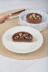 luxury home baked rocher dark rich chocolate tart in 3 layer with hazelnut mixed nuts and gold foil in white background halal dessert menu for hotel cafe