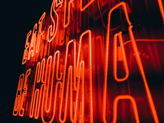 Close-up of red neon lighting lettering 