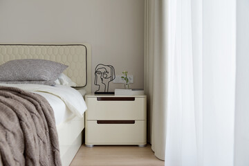 bedroom in light beige tones in a modern apartment, interior of a modern apartment