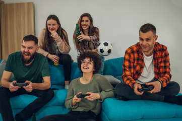 Group of friends playing video games at home