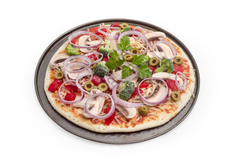 Raw pizza with vegetables and mushrooms on a baking sheet