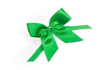 Top view of green satin bow-knot on white background