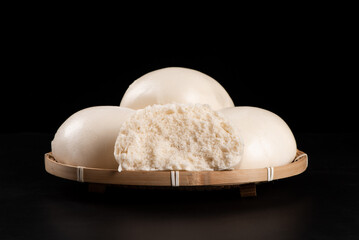 Chinese food steamed buns in bamboo on black background