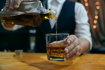 Barman pouring whiskey whiskey glass beautiful night