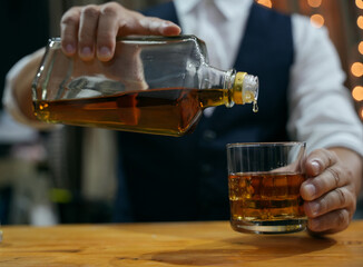Barman pouring whiskey whiskey glass beautiful night