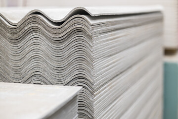 Sheets of construction slate in a stack. Asbestos cement corrugated sheets of roofing material....