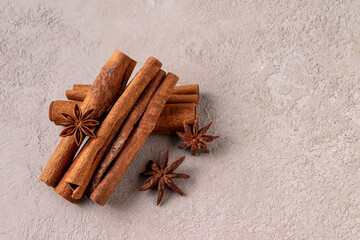 cinnamon sticks and star anise on gray plaster, copy space