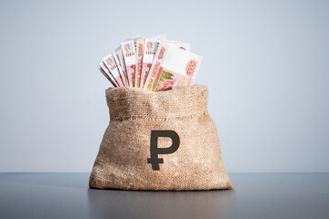Money bag on which rubles sign. Rubles banknotes. Cash money.