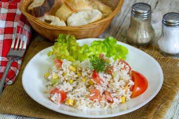 salad rice on a plate with tomatoes and corn