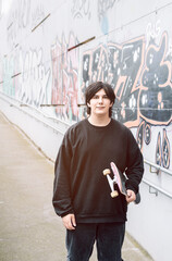 Teenager with a skateboard in his hands