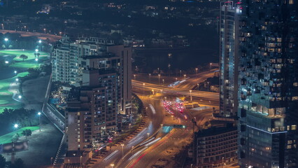 Big crossroad junction between JLT district and Dubai Marina intersected by Sheikh Zayed Road aerial night timelapse.