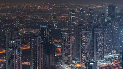 JLT skyscrapers near Sheikh Zayed Road aerial night timelapse. Residential buildings