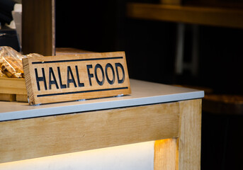 Timber Halal food sign at a restaurant counter.