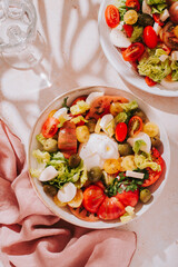 Fresh mediterranean salad with tomatoes and burrata cheese, top view