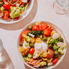 Fresh mediterranean salad with tomatoes and burrata cheese, top view