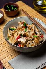 Tofu in teriyaki sauce with green onions, chili peppers and sesame. Asian food. Vegetarian food. Healthy eating.