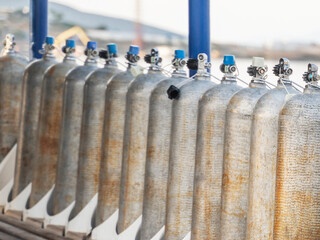 Row of oxigen tanks for scuba diving.