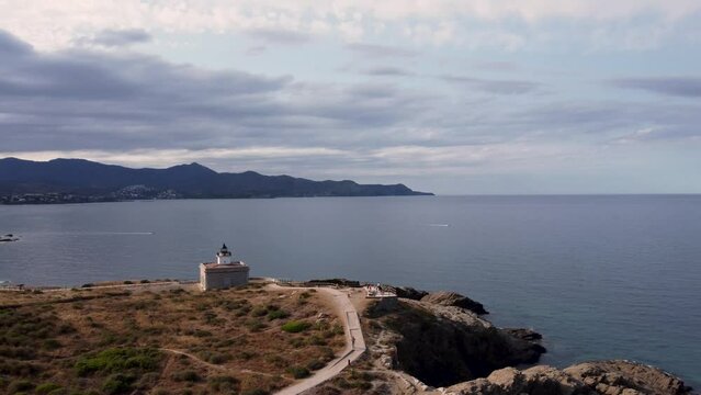 aerial view approaching a lighthouse in Costa Brava, Catalonia, Spain. Beautiful sunset. High quality 4k footage