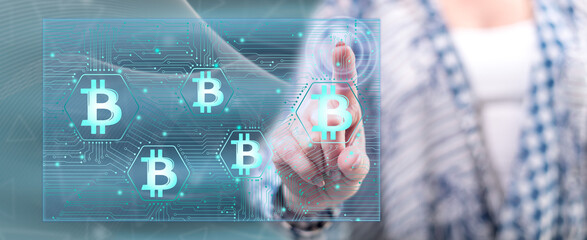 Fototapeta premium Woman touching a bitcoin concept