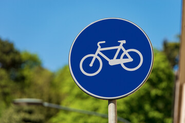 Close-up of a blue road sign of a cycle path in the center of an Italian city. Italy, Europe. Photography.
