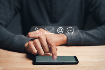 Customer support hotline Contact us people connection. Businessman using smartphone with the email, call phone, address, Chat message icons.