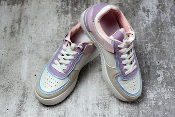 Sports sneakers with laces, on a concrete background. Sport shoes. Side and top view.
