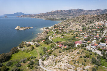 Fototapeta na wymiar Lake Bafa is a lake and a nature reserve situated in southwestern. At the innermost north-east tip of the lake is the village of Kapikiri, as well as the ruins of Heraclea by Latmus.