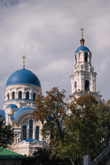 Uspensky cathedral and bell tower of Uspenskaya Tikhonova Pustyn on sunny summer day. Leo Tolstoy village, Kaluga Oblast, Russia.
