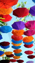 Fototapeta na wymiar Colorful umbrellas in the sky, street decoration background.
