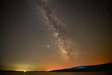 Naklejka na ściany i meble A breathtaking view of the Milky Way at night in Arpi lake, Armenia