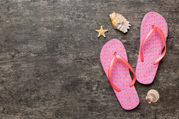 Flat lay composition with flip flops and seashell on colored background. Space for text top view