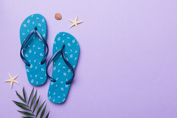 Flat lay composition with flip flops and seashell on colored background. Space for text top view