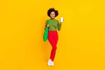 Fototapeta na wymiar Full length photo of young girl hold mobile scan document coronavirus shopping center isolated over yellow color background