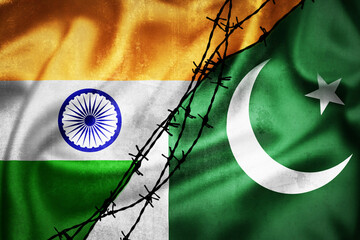 Grunge flags of India and Pakistan divided by barb wire illustration