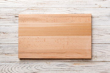 Top view of wooden cutting board on wooden background. Empty space for your design.=