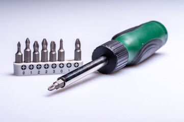 Interchangeable screwdriver set with different types of metal steel heads and bits, closeup