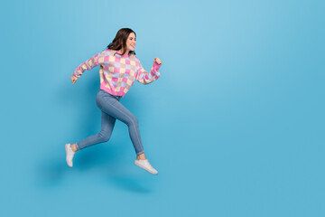 Fototapeta na wymiar Full size photo of young pretty lady runner jumper hurry fast movement isolated over blue color background