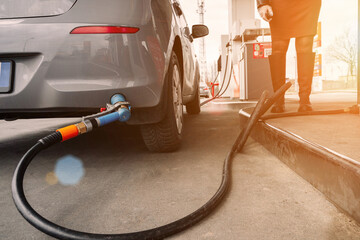Refueling car. Pump gas at petrol fuel station. Gasoline oil nozzle tank from hand person....