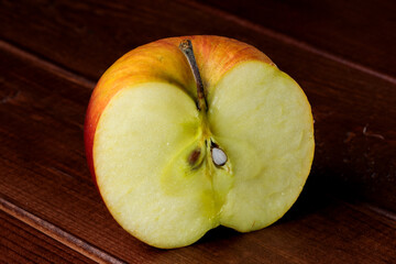 Halve of spoiled shriveled rotting apple