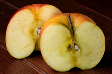 Halves of spoiled shriveled rotting apples