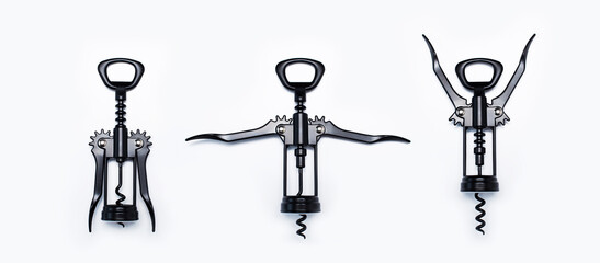 Set of three levels of black metal wine bottle openers on white background. - obrazy, fototapety, plakaty