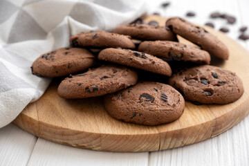 Homemade vegan cookies of cereal on wooden board with kitchen towel. Recipe of sugar free cookies with raisins and nuts, vegan diet snack. Snack or treat for tea or coffee.