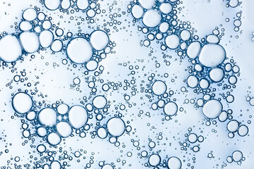 Oxygen bubbles in liquid skincare gel serum macro texture background top view
