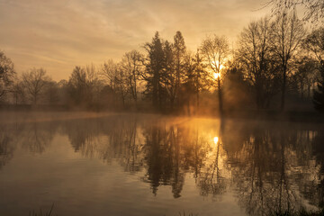 Fototapeta na wymiar Misty sunrise over the ponds