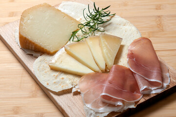 pecorino with typical carasau bread, raw ham, from Sardinia