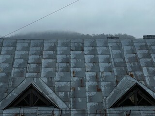 old house roof in fog